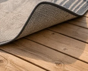 outdoor-carpet-wooden-deck-backing-underside.webp Alt Text: Outdoor carpet wooden deck backing shown lifted off the boards.