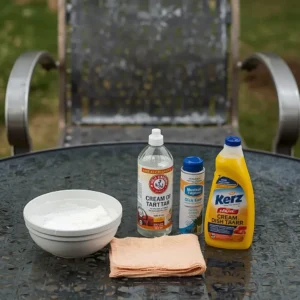 Cleaning supplies ready to treat oxidized aluminum patio chairs with a cream of tartar method.