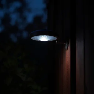 Solar lights stop working close up of a dim flickering fixture at night.