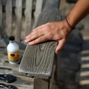 Inspecting weathered teak wood furniture before starting the restoration process.