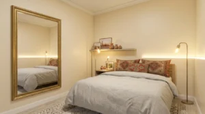Budget mirror and bulb setup that shows how to brighten dark, windowless bedroom spaces cheaply.