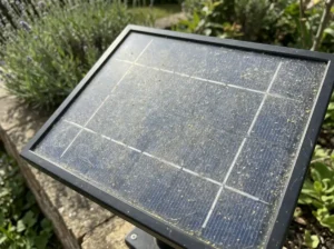 Cloudy solar light panel surface showing dust and pollen film buildup.