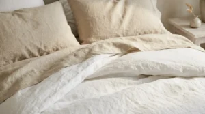 Washed linen bedding texture showing which coastal grandmother decor works best.